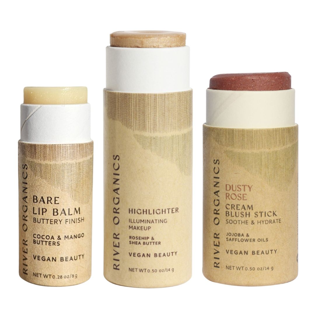 River Organics' Lip + Highlighter + Blush Set features clean beauty formulas and plastic-free packaging, with each product in an eco-friendly cardboard tube and minimalist beige label.