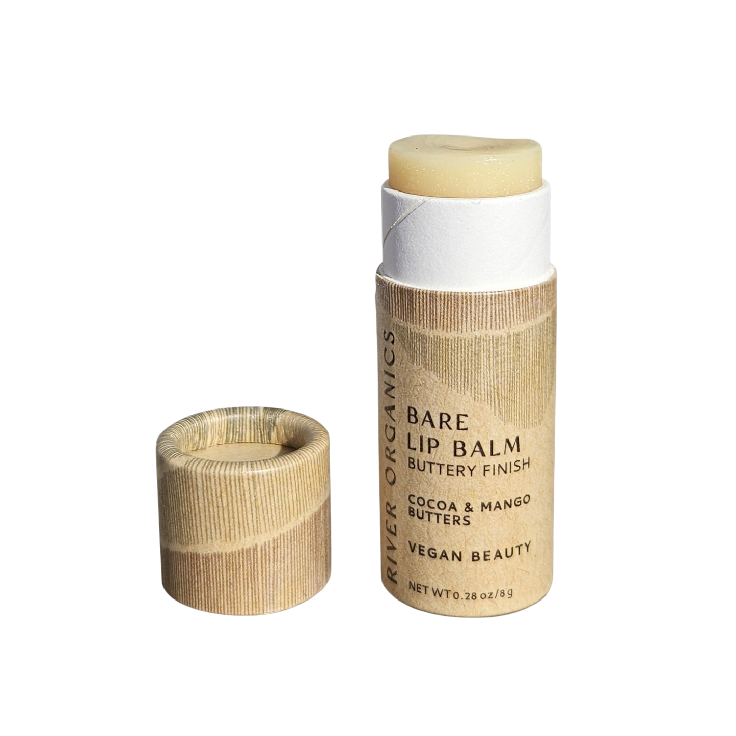 A cardboard tube of River Organics Bare Vegan Lip Balm with the cap off reveals the balm. The label states it’s vegan and contains cocoa and mango butters.