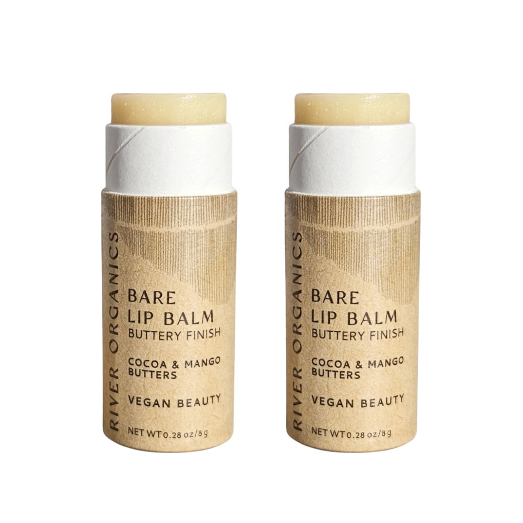 Two River Organics Bare Lip Balm Bundles in tan paper packaging, labeled "Bare Lip Balm, Buttery Finish, Cocoa & Mango Butters, Vegan Beauty." Both zero-waste balms are partially uncapped to reveal the product.
