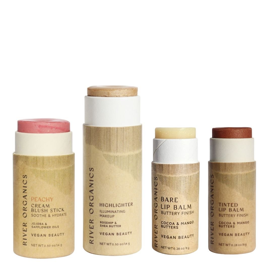 River Organics' Makeup Color Set by Tone includes a blush, highlighter, and two lip products in cardboard tubes with minimalist brown labels—vegan, zero-waste beauty essentials for sustainable makeup gift sets.