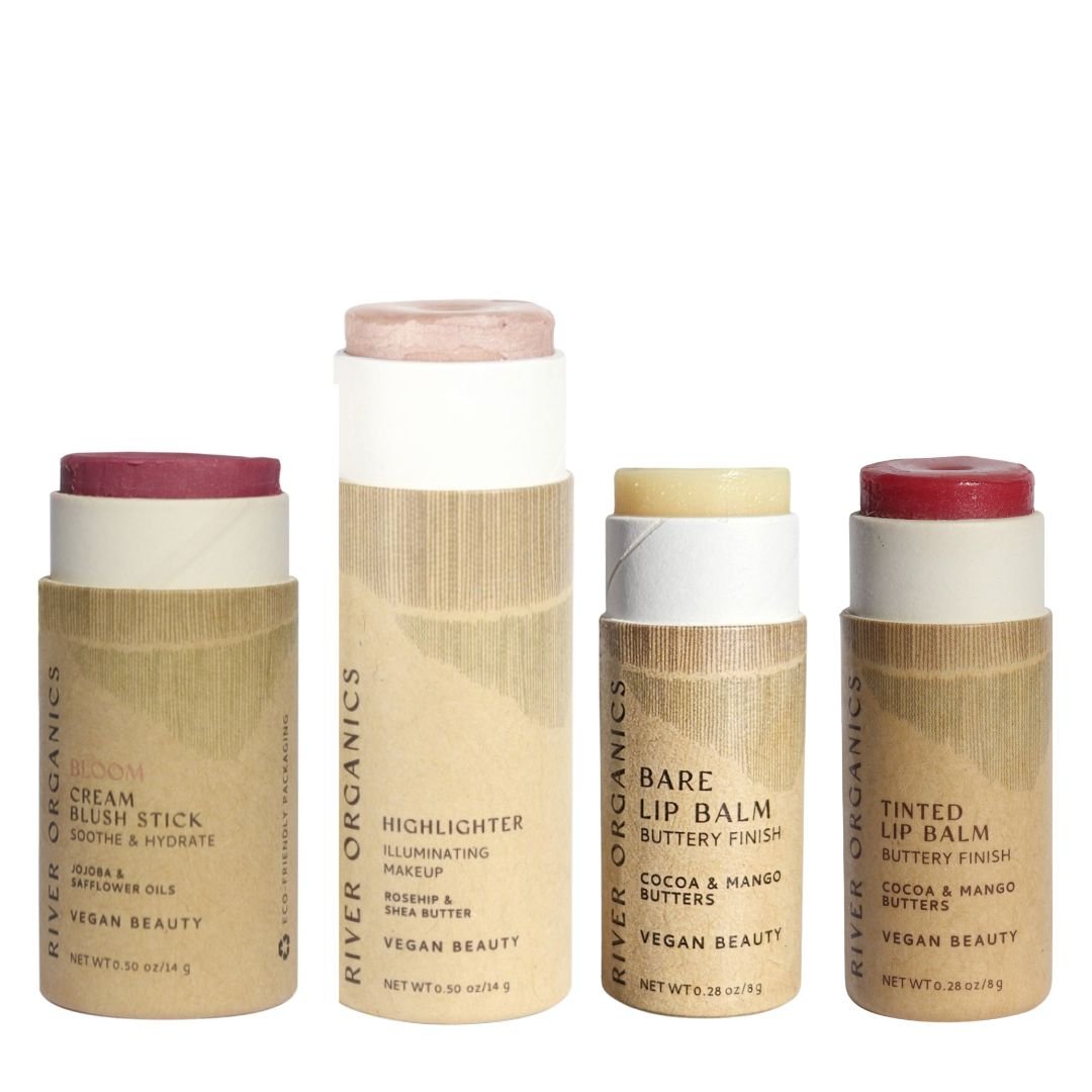 Four cardboard tubes of River Organics' Makeup Color Set by Tone are shown: blush, highlighter, and two lip products—ideal for sustainable makeup gift sets, with each product visible above its tube.