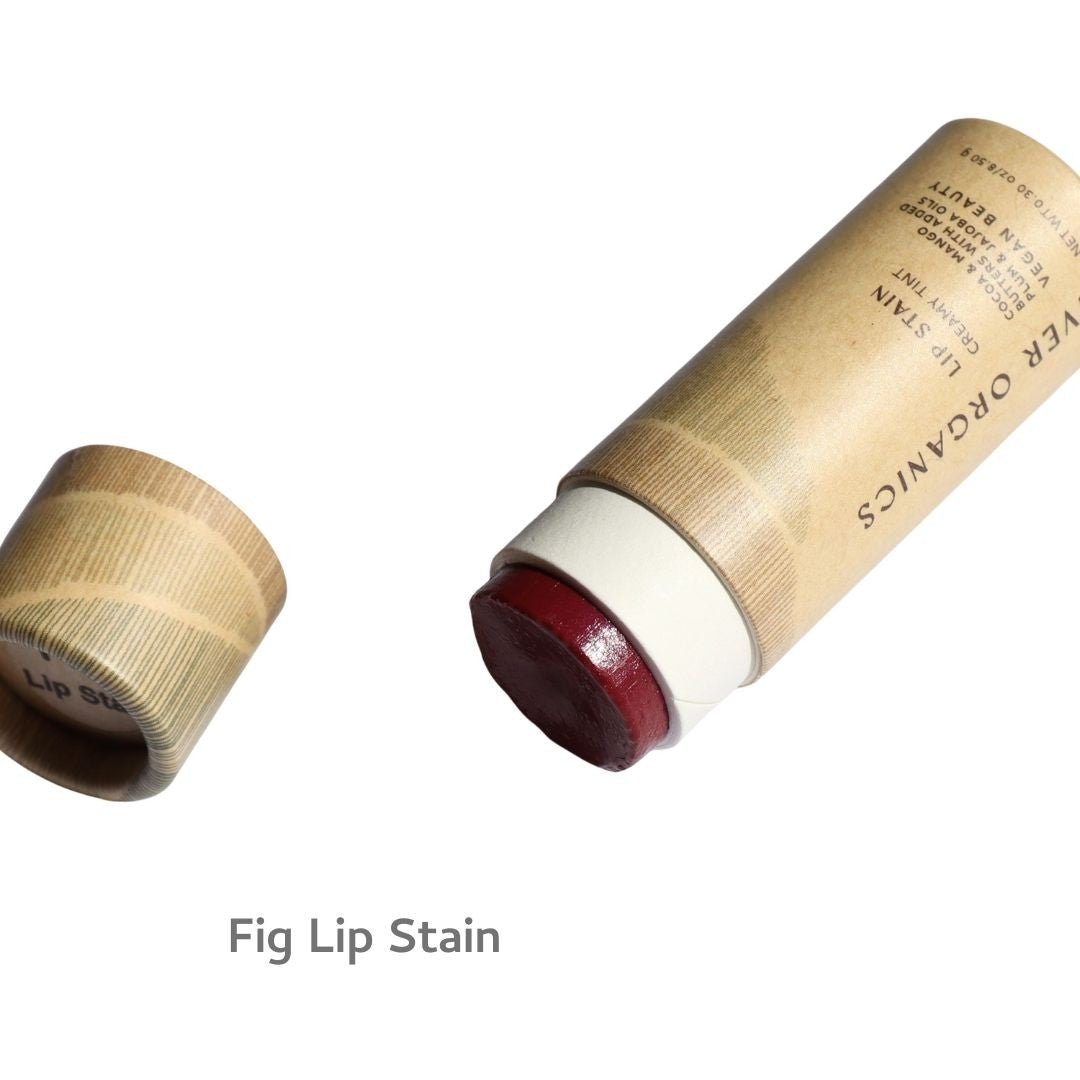 A tube of River Organics Vegan Lip Stains in red, with the cap off to display the product. The text "Vegan Lip Stains" appears below the image.