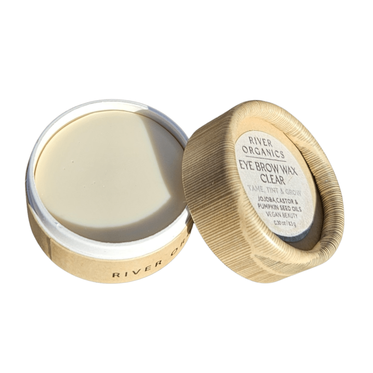 A small round container from River Organics' Eye Duo Set: Brow Wax + Mascara sits with the lid partially open, revealing smooth, pale eyebrow wax. The label notes zero-waste vegan essentials and nourishing jojoba and pumpkin seed oils.