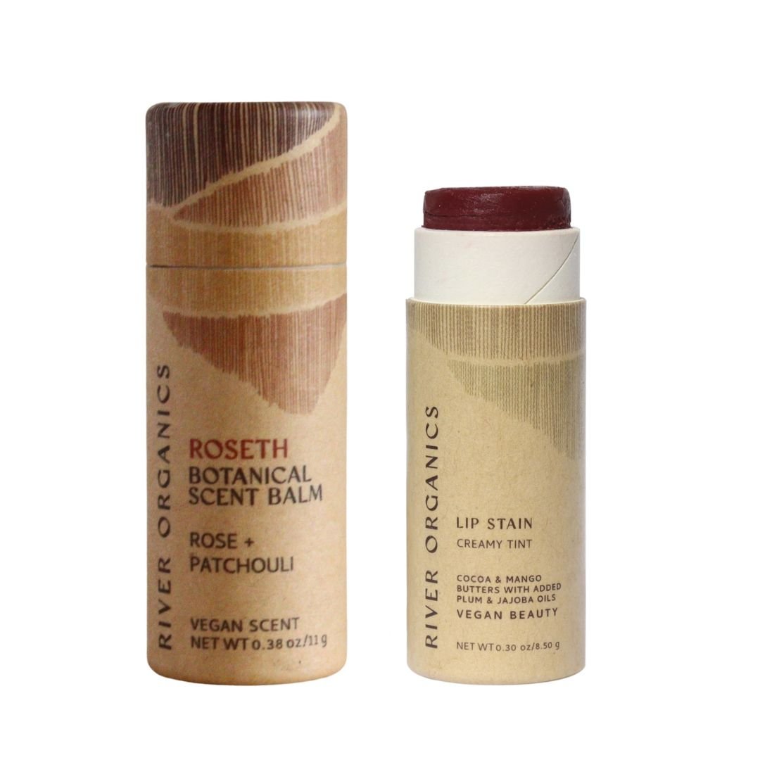 River Organics' Lip + Scent Balm Bundle features eco-friendly brown tubes with minimalist designs: one holds the Roseth Botanical Scent Balm for a soothing ritual, the other is an open vegan Lip Stain.
