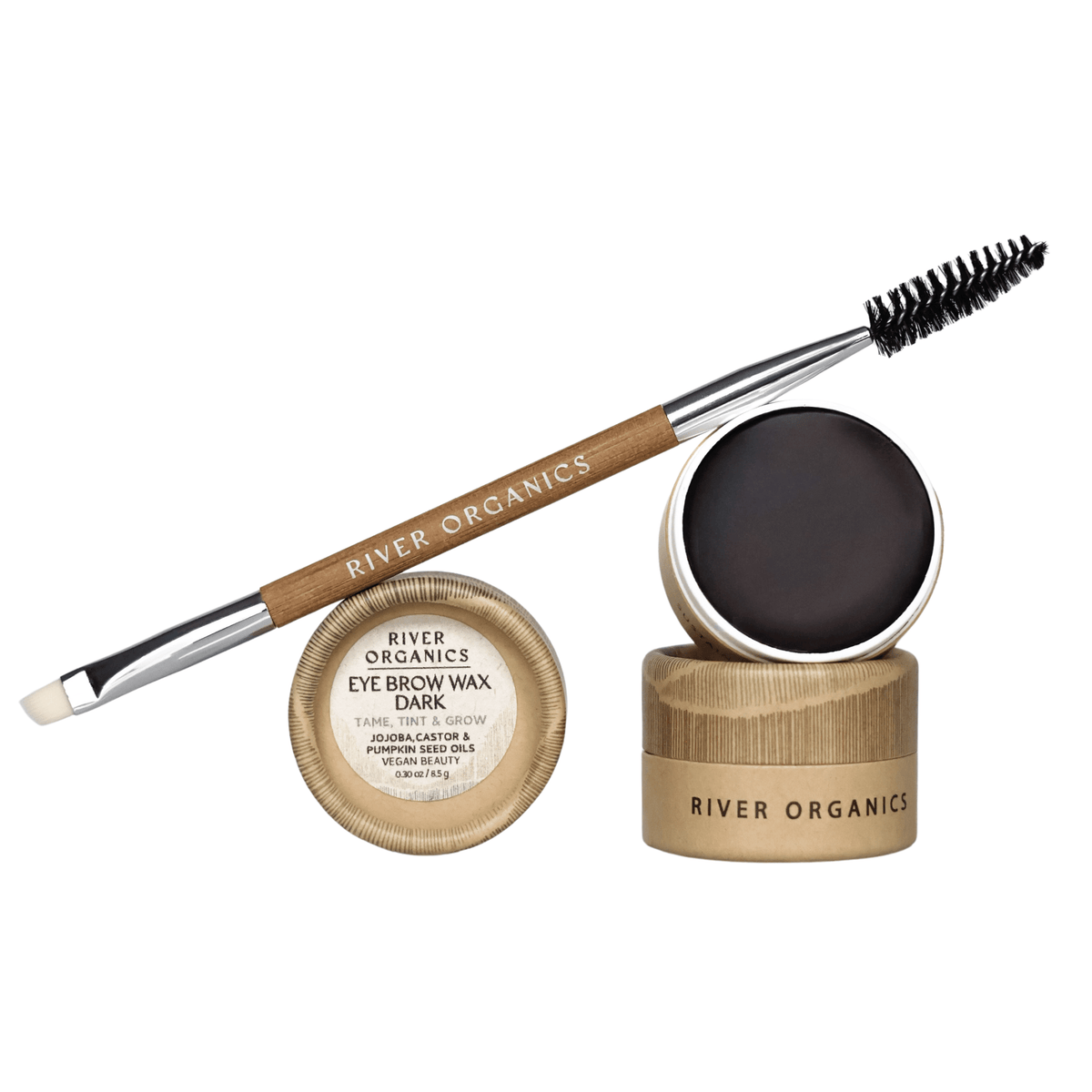 An open tin of River Organics Brow Wax & Growth Serum in dark sits beside a double-ended brow brush with spoolie and angled tip. Both products feature elegant wooden and metal packaging.