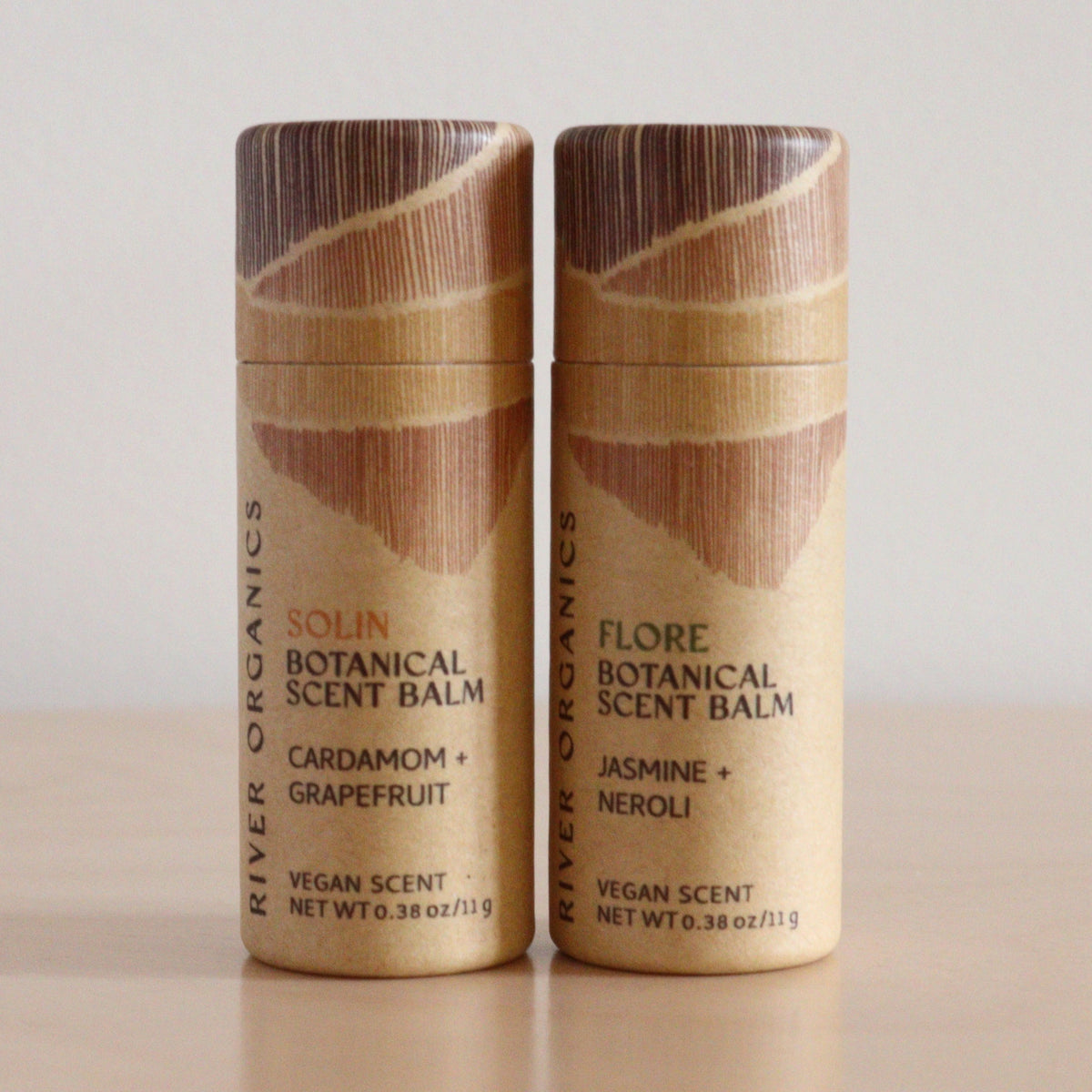 River Organics’ Set of 2 Botanical Scent Balms, made with essential oils, features "Solin Cardamom + Grapefruit" and "Flore Jasmine + Neroli." These vegan balms have wood-patterned lids—ideal for plant-based skincare fans.