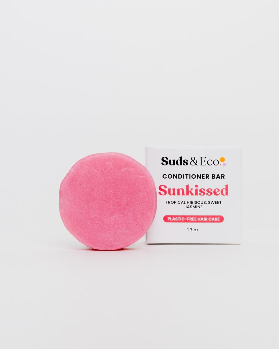 A round, pink sulfate-free Conditioner Bar from ZeroWasteStore.com sits beside its white box labeled “Conditioner Bar – 1.7 oz” on a plain white background.