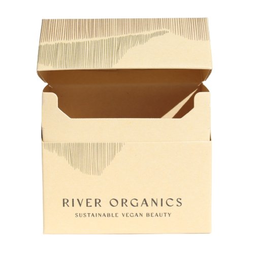 Open beige cardboard Gift Box by River Organics with "Sustainable Vegan Beauty" on the front. It is partially open, showcasing a simple, minimalist design and highlighting thoughtful combinations for a ready-to-enjoy set.