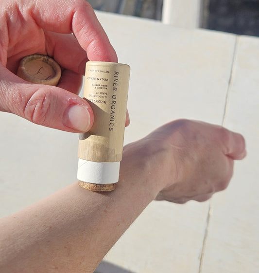 Bronzer re-formulation without Titanium dioxide, being swatched on arm