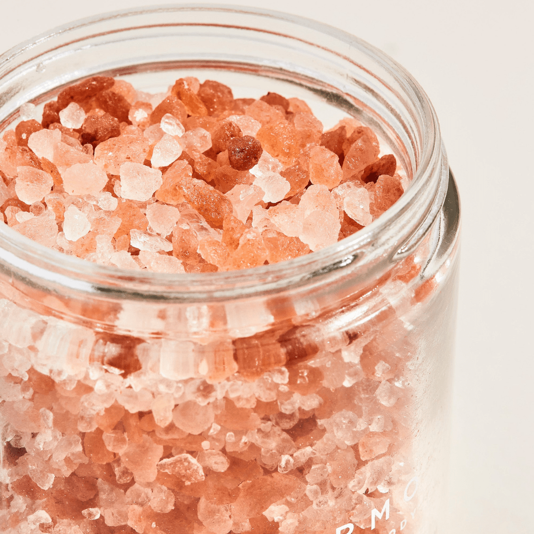 Palermo Body’s Replenishing Salt Soak features coarse Himalayan Pink Salt crystals in varied hues, perfect for a relaxing jasmine-infused bath soak, displayed against a plain light background.