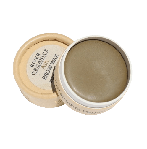 A round, open container of River Organics Brow Wax - Tame, Tint & Grow with a beige lid beside it reveals smooth, taupe-colored vegan wax in eco-friendly packaging, reflecting the brand’s commitment to sustainable beauty.