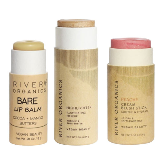 River Organics offers the Lip + Highlighter + Blush Set featuring nourishing lip balm, illuminating highlighter, and peachy blush sticks with minimalist eco-friendly packaging and vegan formulations.