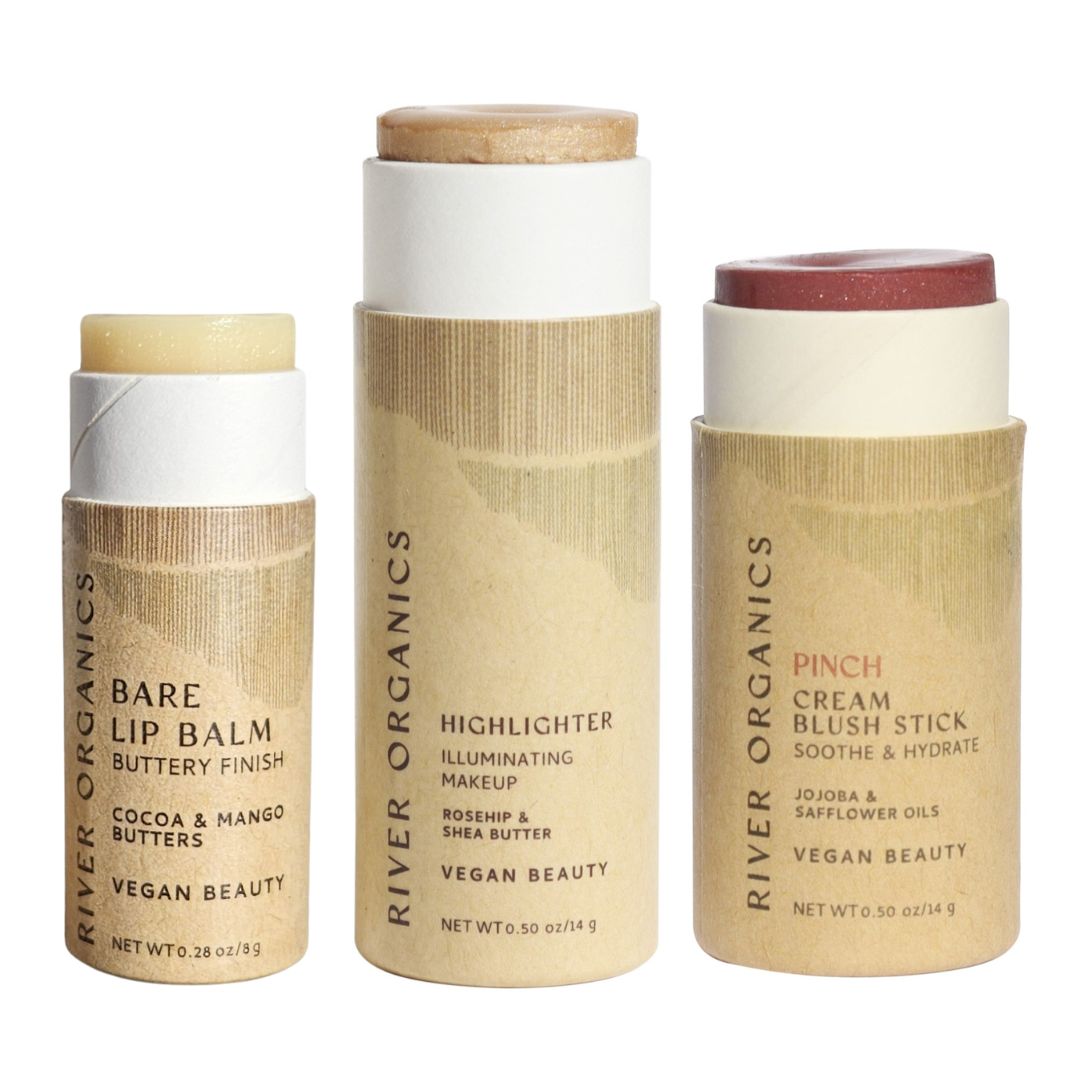 The River Organics Lip + Highlighter + Blush Set features clean beauty essentials in eco-friendly brown paper tubes with minimalist design, delivering plastic-free packaging.