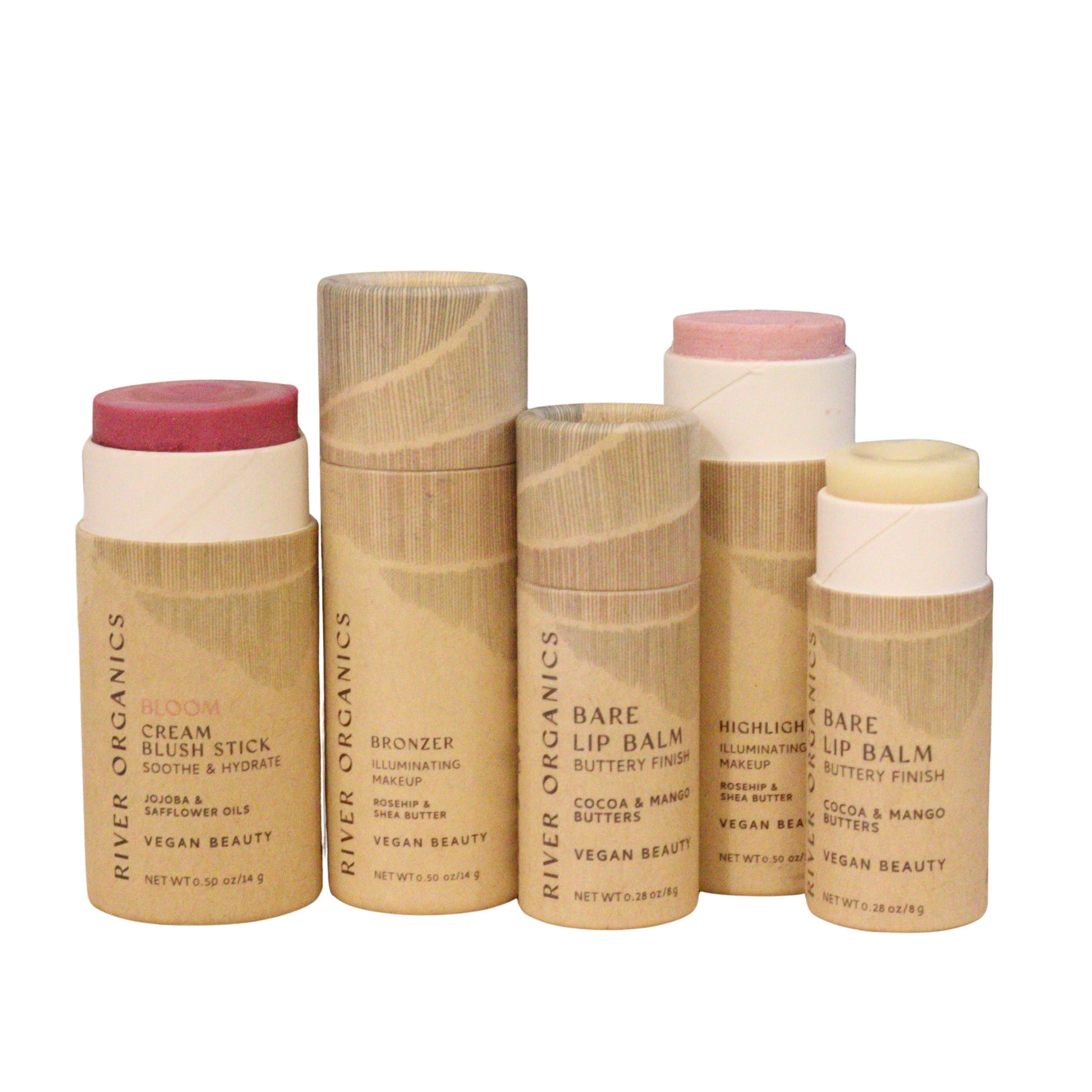 Five cylindrical River Organics Colour Sets include vegan blush, bronzer, zero-waste highlighter, and two lip balms—all in eco-friendly natural packaging with clear product labels.