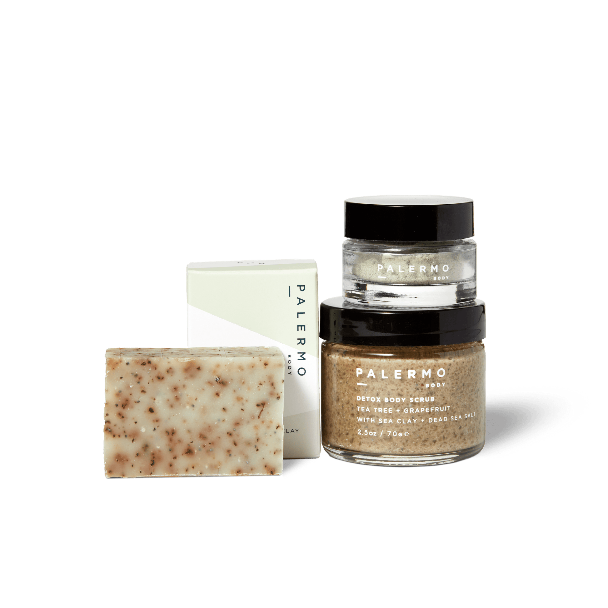 The Palermo Body Detox + Clarify Mindful Kit includes a tea tree soap bar, detox body scrub jar, and clay mask jar, all with visible product labels arranged on a white background.