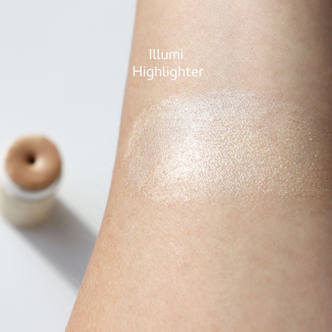 Close-up of a forearm showcasing a shimmery highlighter with non-toxic ingredients. "Highlighter and Bronzer Set" by River Organics glows above, while a small, open container flaunts its long-wearing formula in the background.