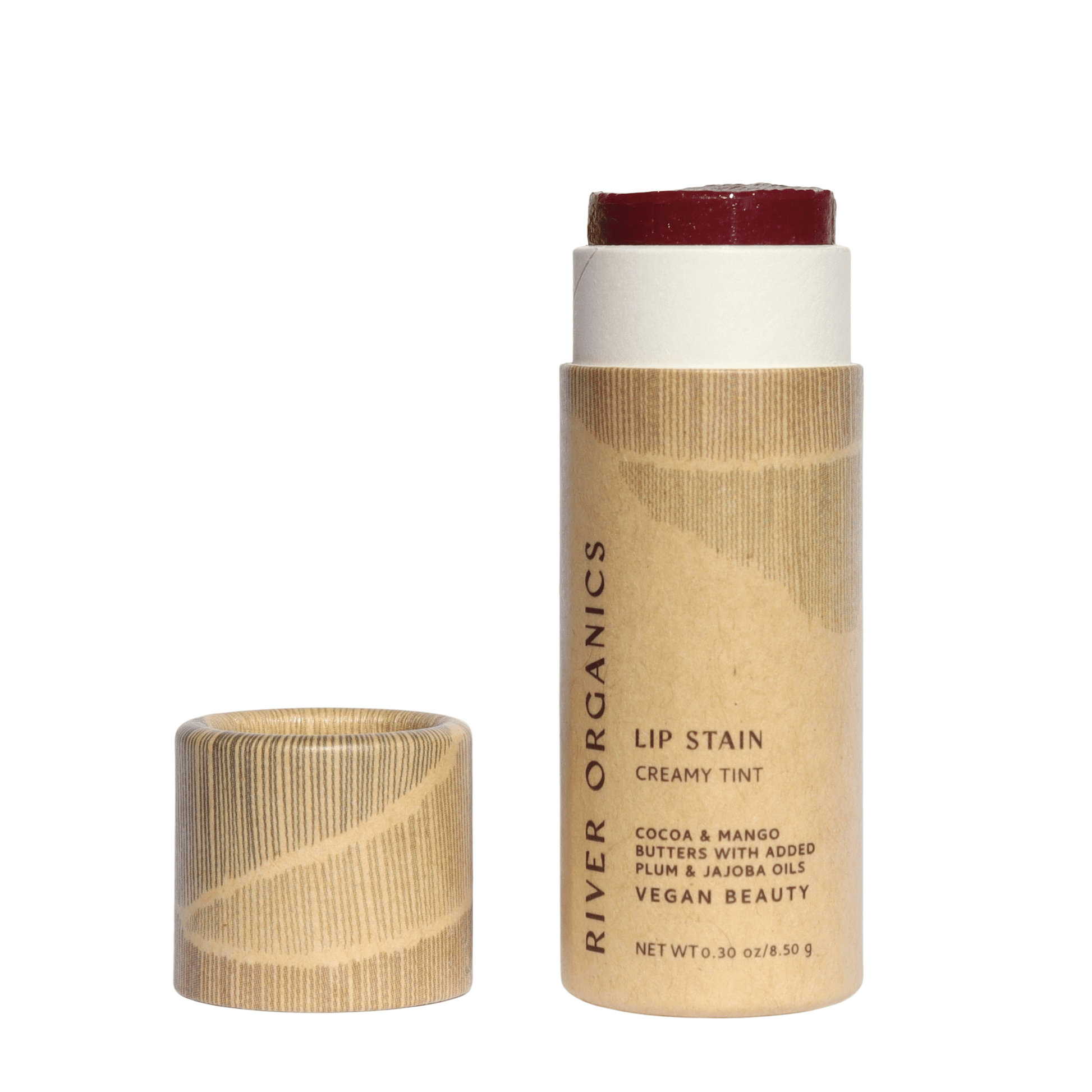A tube from the River Organics Lip Stain Sets, with a creamy deep red tint, stands by its cap. The eco-friendly packaging has a natural look, highlighting its vegan and organic ingredients while being non-toxic.