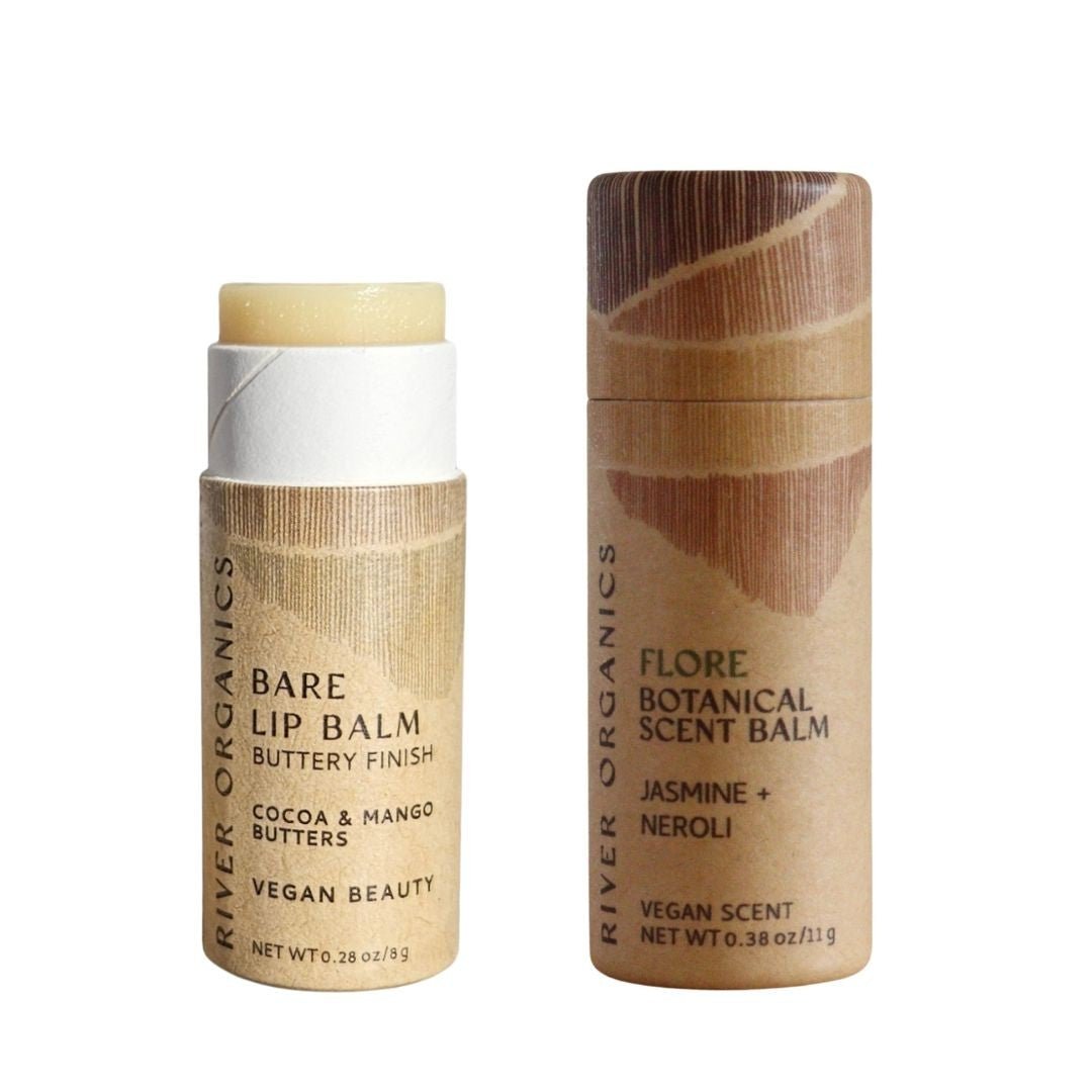 River Organics' Lip + Scent Balm Bundle features two brown, eco-friendly tubes—one open with Vegan Lip Balm and one closed labeled Flore Scent Balm. Both showcase minimalist, natural packaging for your daily botanical ritual.