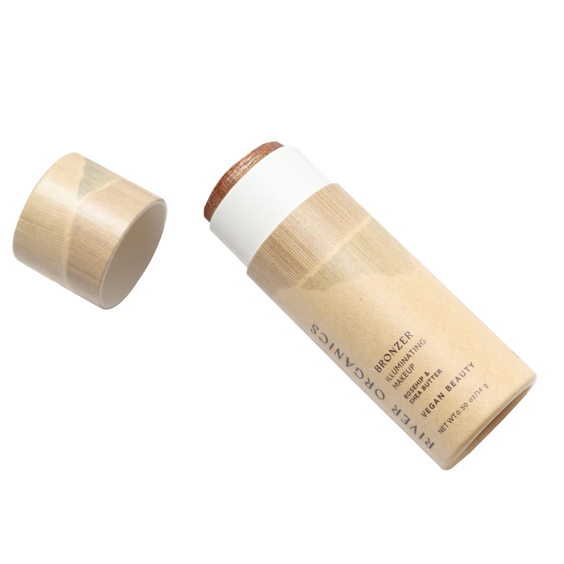 The Shimmery Face and Body Bronzer Stick by River Organics comes in a minimalist, eco-friendly cardboard tube with the lid off. Vegan and organic, it features a natural-looking bronzer that's partially extended, showcasing its commitment to using only vegan ingredients.