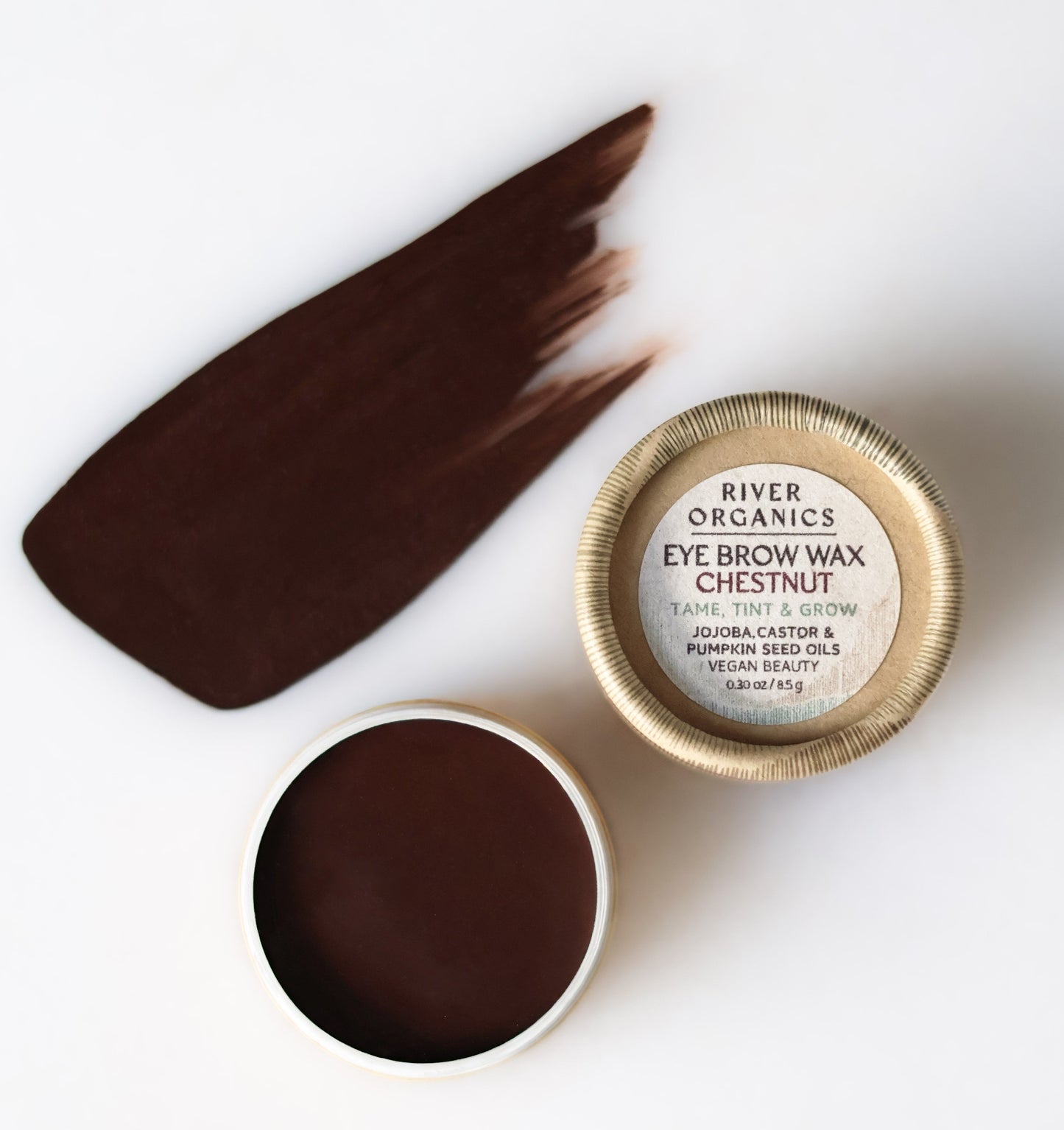 An open tin of River Organics Brow Wax & Growth Serum in Chestnut sits beside its lid, displaying a brown swatch on a white background. The packaging showcases vegan ingredients for naturally defined, beautiful brows.