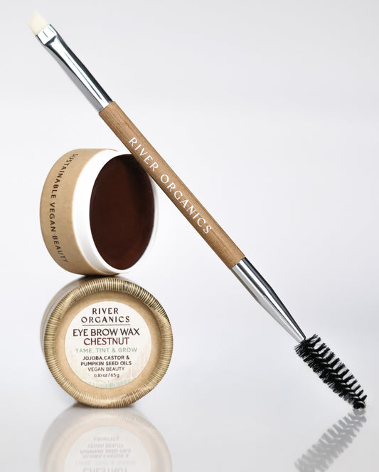 A small circular container of chestnut-colored River Organics Brow Wax & Growth Serum and a dual-ended makeup brush with a spoolie and an angled tip.