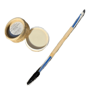 The River Organics Imperfect Brow Wax & Growth Serum is a vegan styling kit with a clear brow wax in an open round container and a dual-ended brush featuring a spoolie and flat angled tip for precise application.