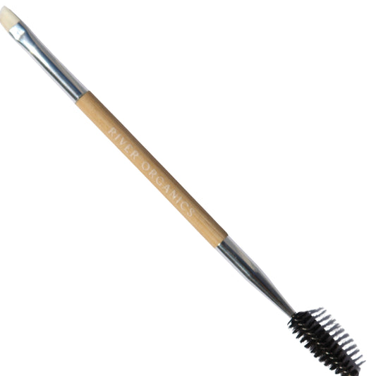 The "Bare Wood Brow and Lash Brush" by River Organics is a dual-ended makeup tool with a wooden handle. One end has an angled brush for brow wax, while the other features a spoolie for grooming eyelashes or eyebrows.