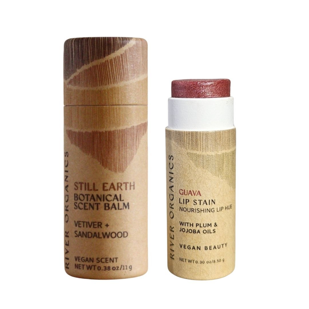 River Organics’ Lip + Scent Balm Bundle includes a Vetiver + Sandalwood Scent Balm and an open, rosy-tinted Guava Vegan Lip Balm in eco-friendly beige packaging—perfect for your Botanical Ritual.