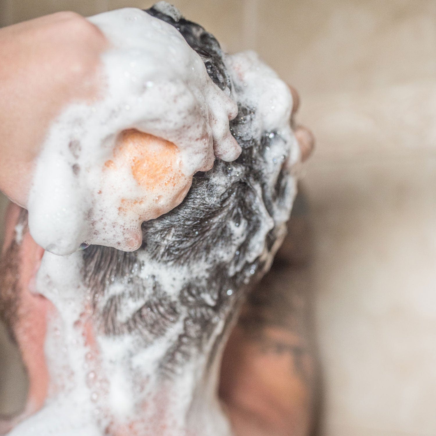 A person massages ZeroWasteStore.com’s Shampoo Bar into a rich lather on wet hair, with the close-up focusing on thick foam and highlighting the bar’s eco-friendly cleansing.