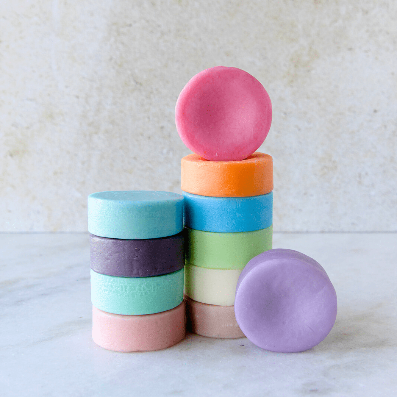 A stack of colorful, round Conditioner Bars from ZeroWasteStore.com—an eco-friendly choice for a zero waste hair care routine.