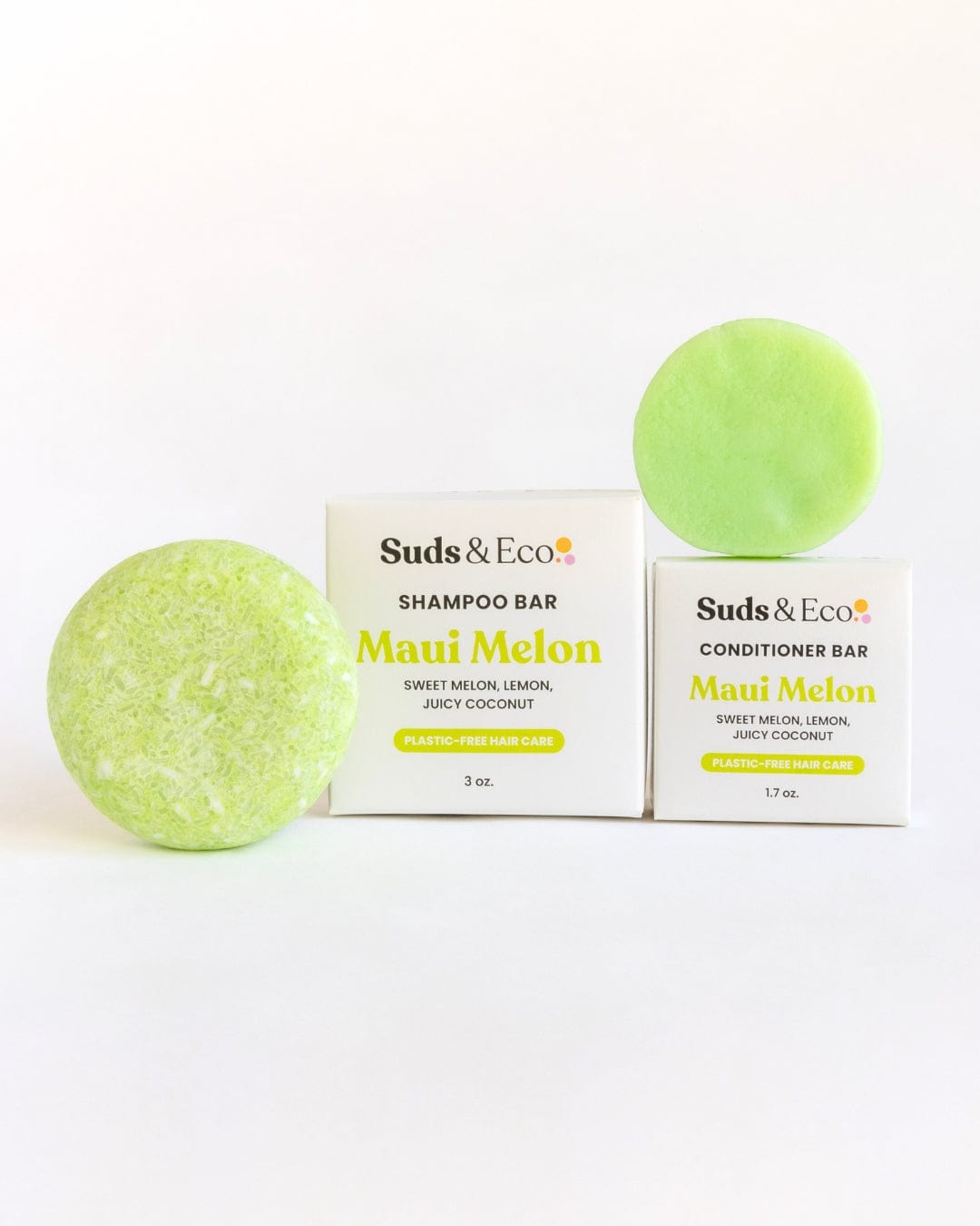 The ZeroWasteStore.com Shampoo & Conditioner Bar Duo, featuring a large speckled green shampoo bar and a smaller smooth conditioner bar with Maui Melon boxes, is displayed on a light background, highlighting their zero waste and vegan benefits.