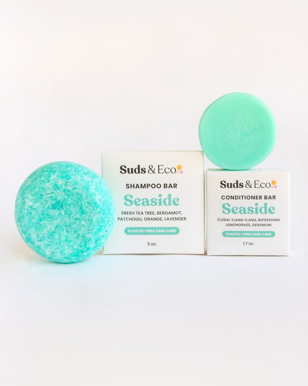 Two turquoise Shampoo & Conditioner Bar Duos from ZeroWasteStore.com are placed in front of white boxes labeled "Seaside." The zero waste packaging highlights fresh, floral, and citrus scents against a plain white background.
