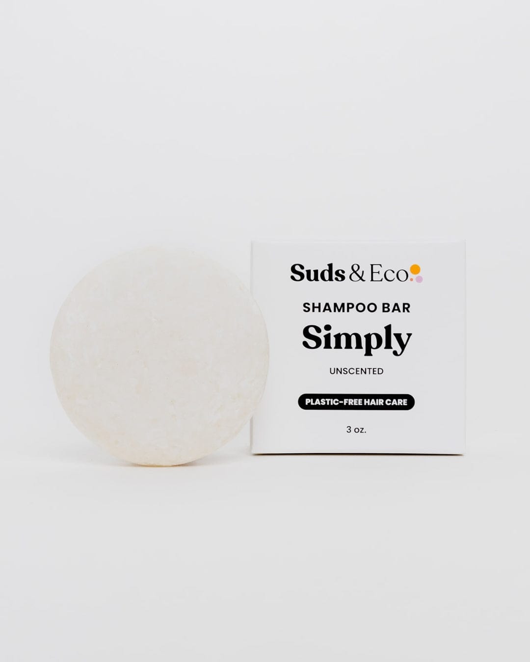 A round, white Shampoo Bar from ZeroWasteStore.com sits beside a white box labeled "Shampoo Bar, Plastic-Free Hair Care, 3 oz." This vegan, zero waste shampoo is ideal for eco-conscious hair care on a plain white background.
