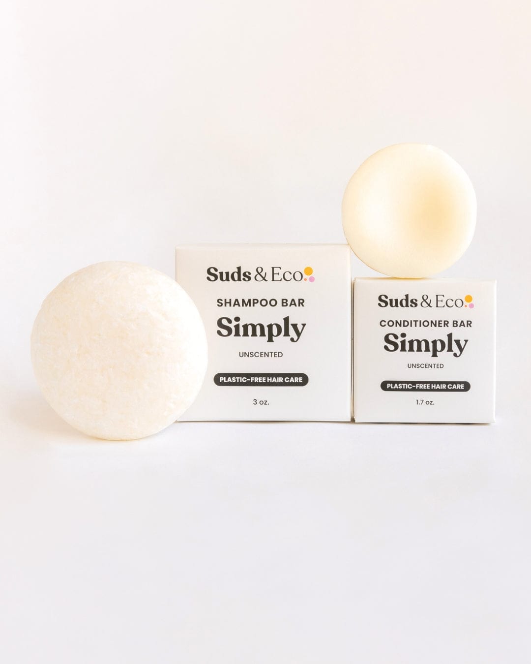 The Shampoo & Conditioner Bar Duo by ZeroWasteStore.com features round, white bars with their boxes on a white background, showcasing a zero-waste, plastic-free hair care option.