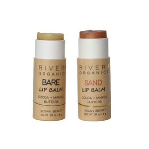 Two tubes of River Organics Skincare Set of 2 Lip Balm are shown. One is labeled "Bare" and the other "Sand." Both state they contain cocoa and mango butters and are vegan beauty products with a cruelty-free certified, vegan formula. Each has 0.28 oz (8g) of balm in eco-friendly, minimalist packaging.