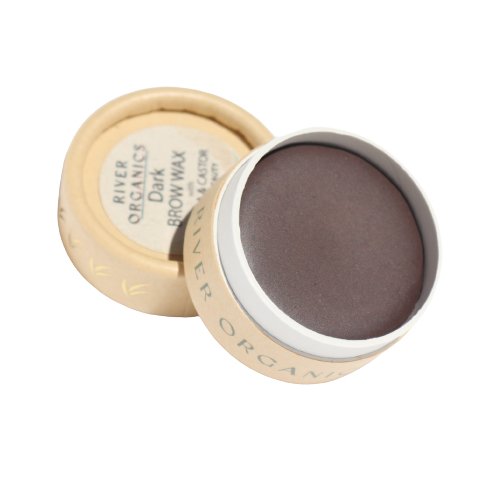 A small, round, open container of River Organics Tinted Vegan Eyebrow Wax | Dark. The lid, set to the side, reveals a label detailing product information. The container has a minimalistic beige design with the brand name printed around the sides, offering a natural brow color for all your grooming needs.