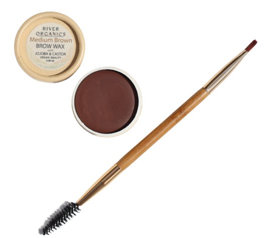 An open container of River Organics Skincare Tinted Vegan Eyebrow Wax | Medium Brown, a vegan brow color, sits with the lid beside it, revealing the product's smooth brown surface. Alongside is a double-ended applicator brush with a spoolie on one end and an angled brush on the other. This tinted eyebrow wax is cruelty-free certified.