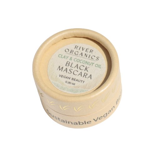 A small, round, beige container with a lid labeled "River Organics Black Zero-Waste Mascara," and the words "Sustainable, Chemical Free Vegan Beauty" around the base. The eco-friendly packaging underscores its commitment to being a coconut oil mascara.